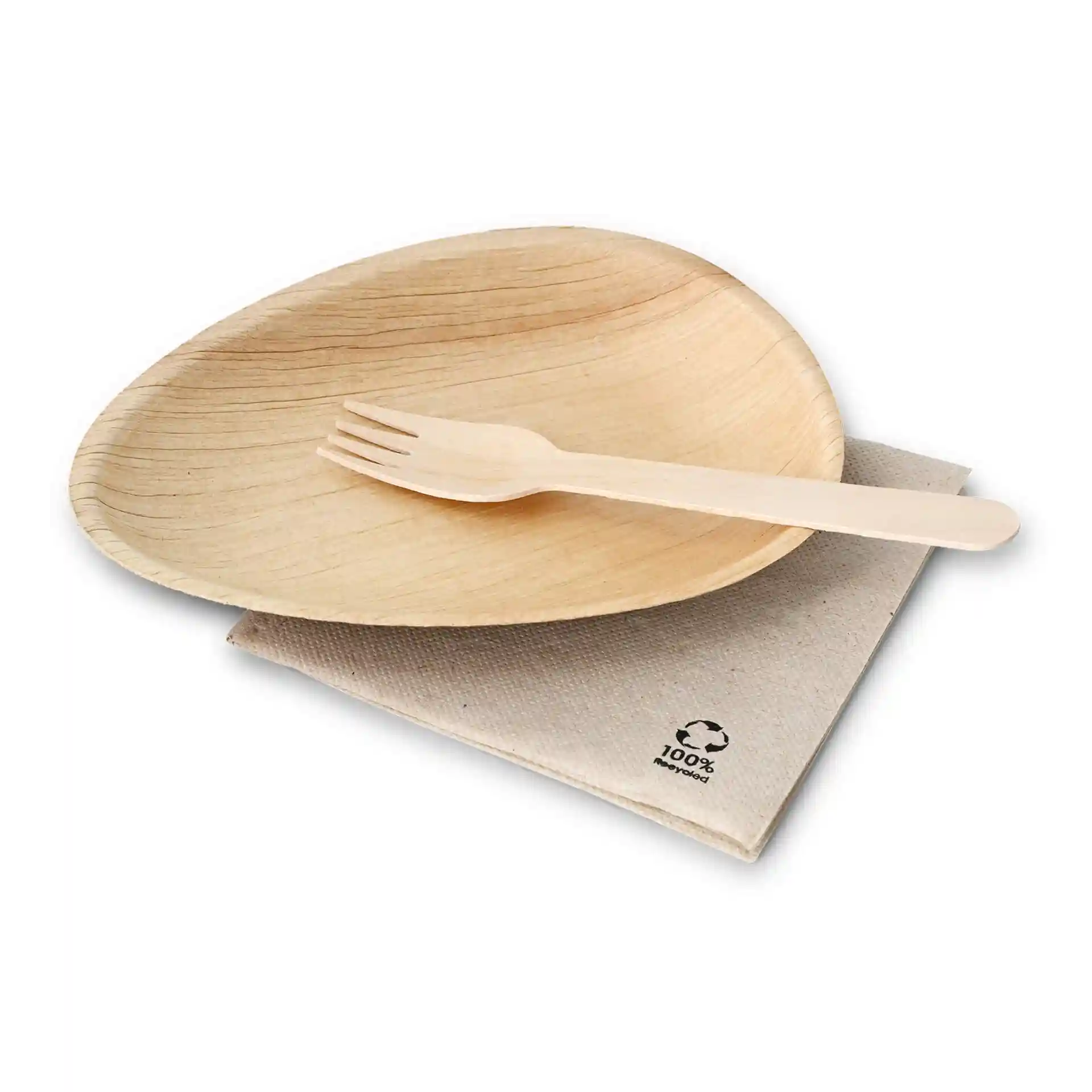 Oval palm leaf plate with a wooden fork placed on a beige cloth napkin.