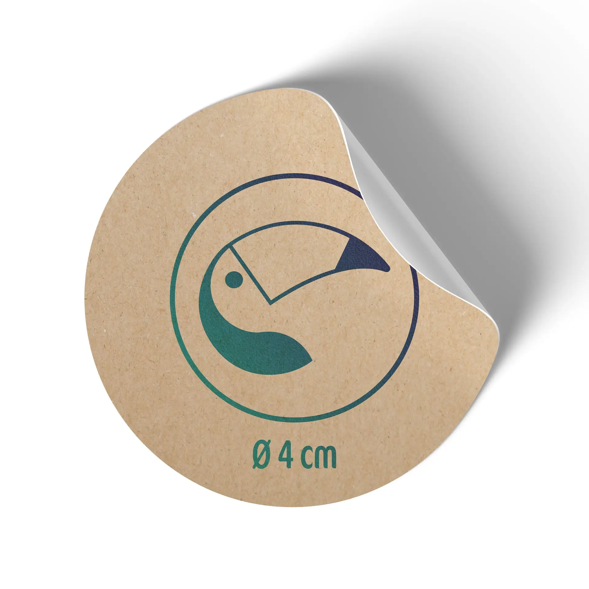 Round kraft paper label with a toucan design, measuring 4 cm in diameter, showing a partially peeled corner.