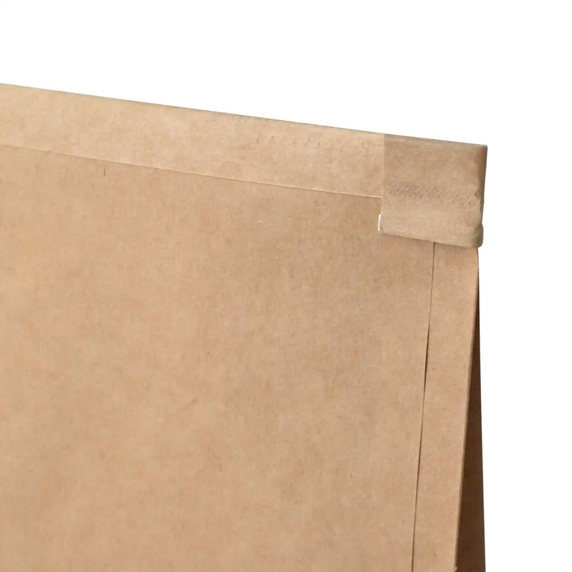 Brown kraft paper block bottom bag with a tin tie closure, showing the top edge and fold.