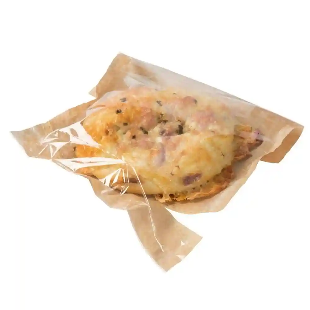 Snack bag made of printed paper with a palm leaf design, containing a food item wrapped in clear film.