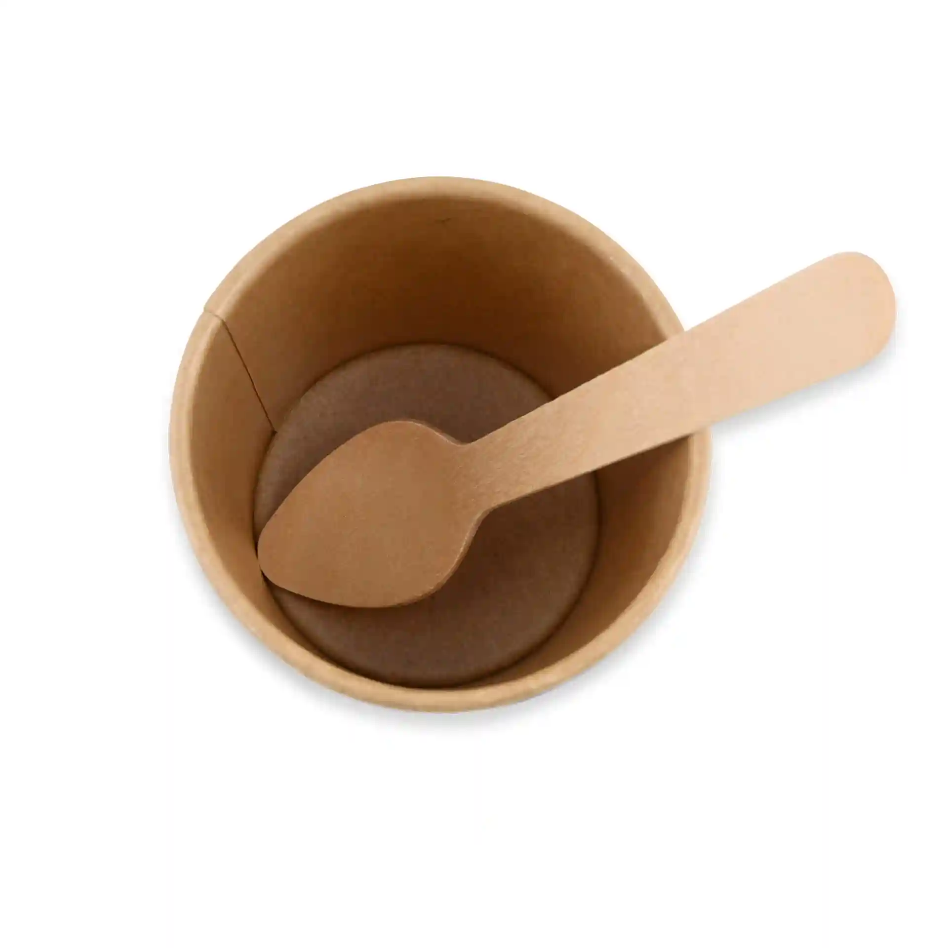 Brown paper cup with a wooden spoon resting inside, viewed from above.