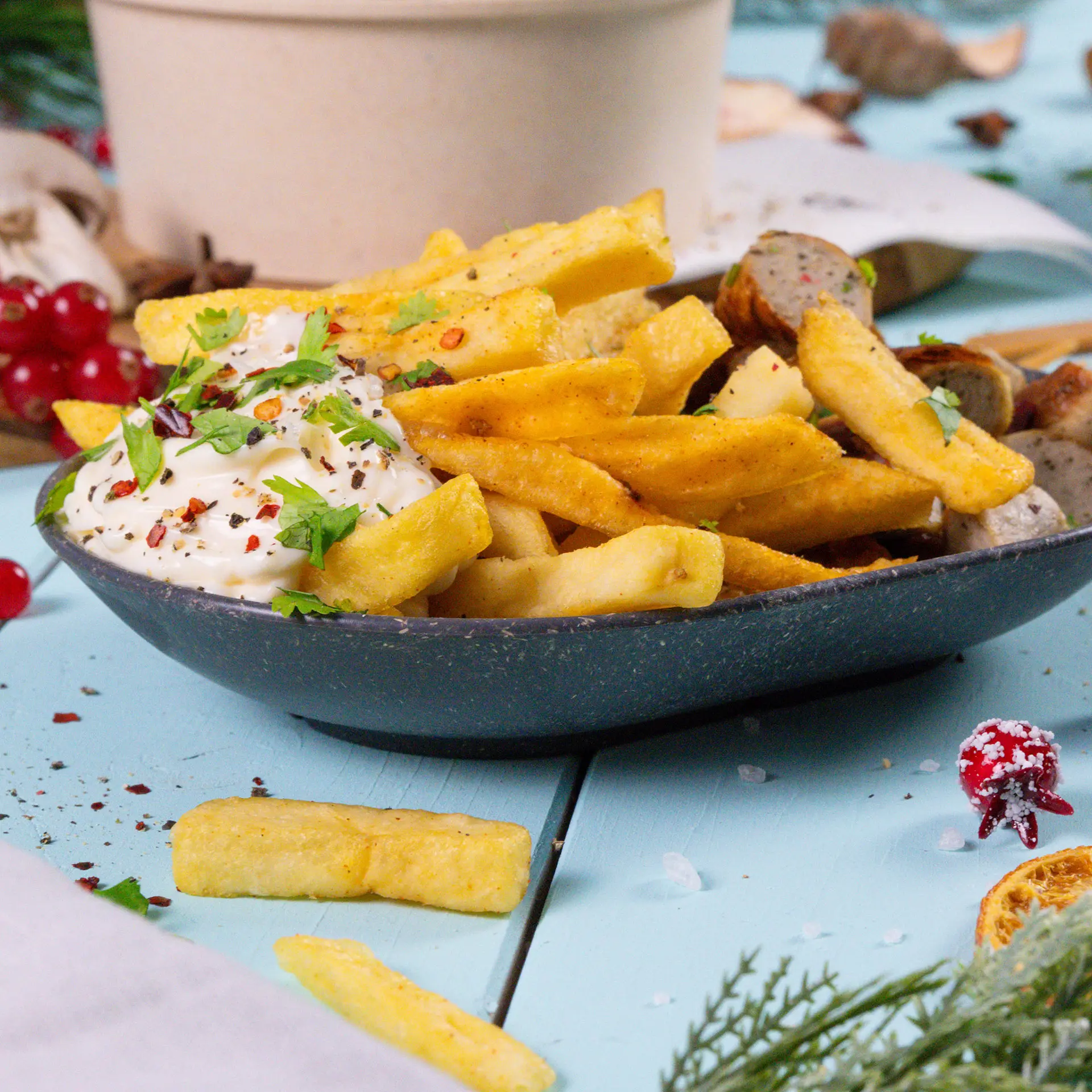 A serving of French fries topped with salsa, sliced red chilies, and cilantro in a reusable snack bowl.