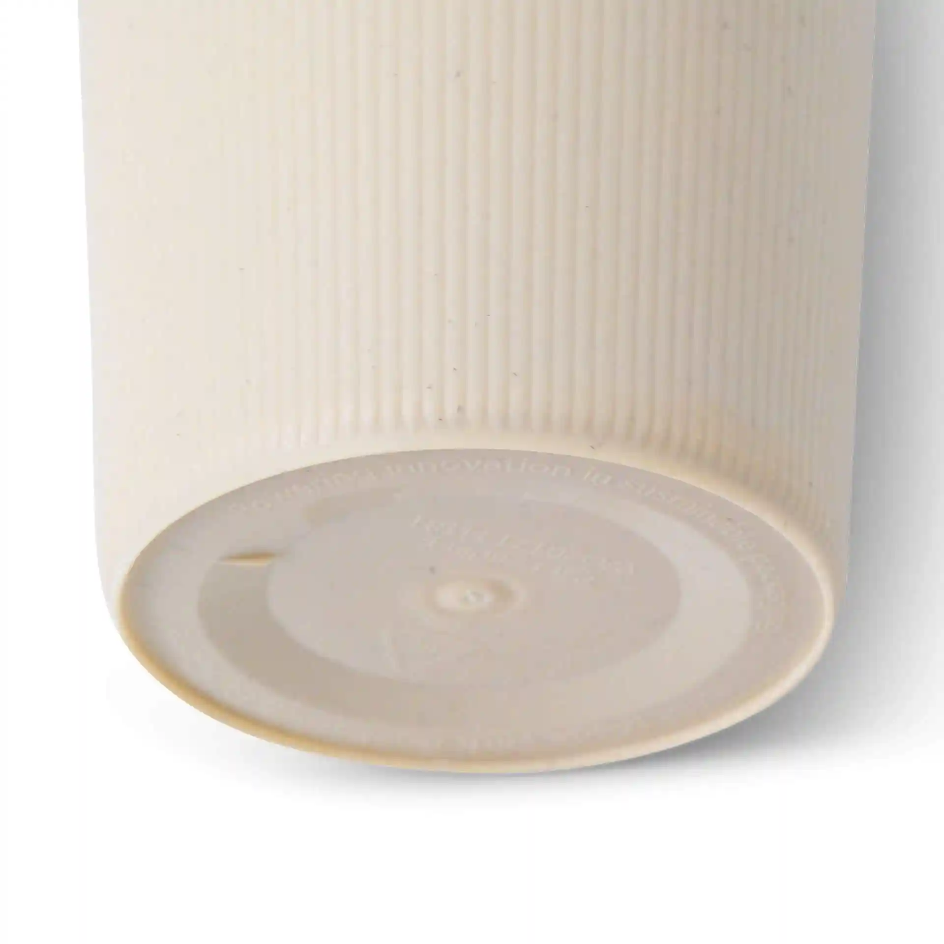 Cream white ribbed reusable cup with a round shape, showing the bottom and a smooth surface.