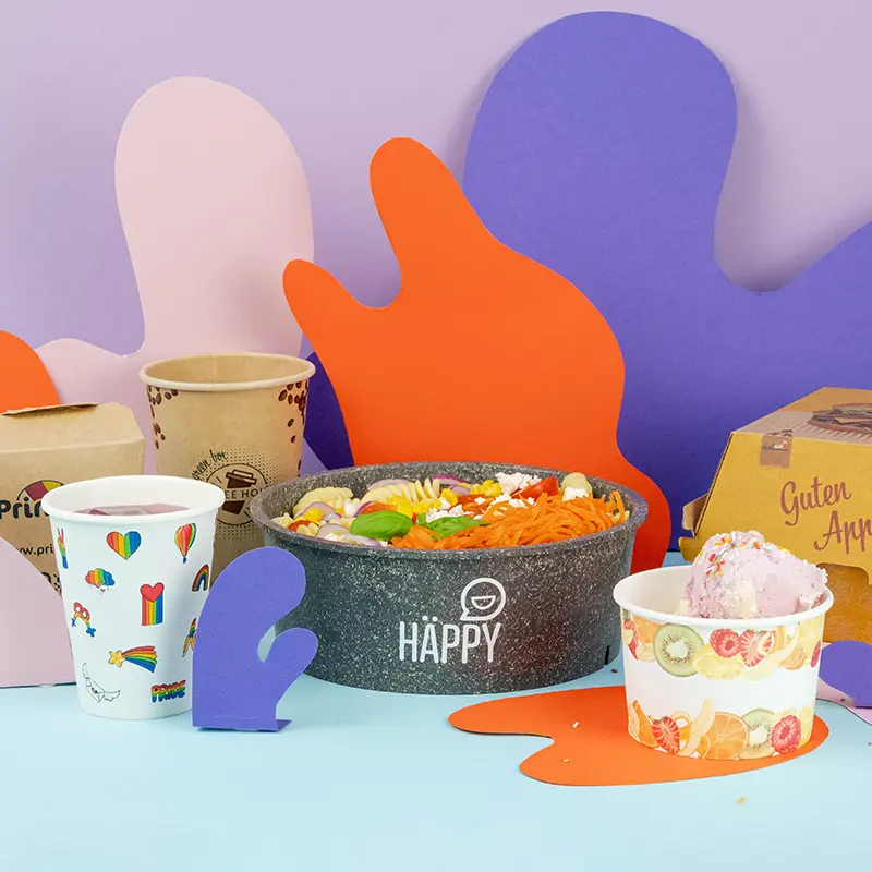 Collection of custom printed food packaging items, including containers, cups, and a bag with various design labels.