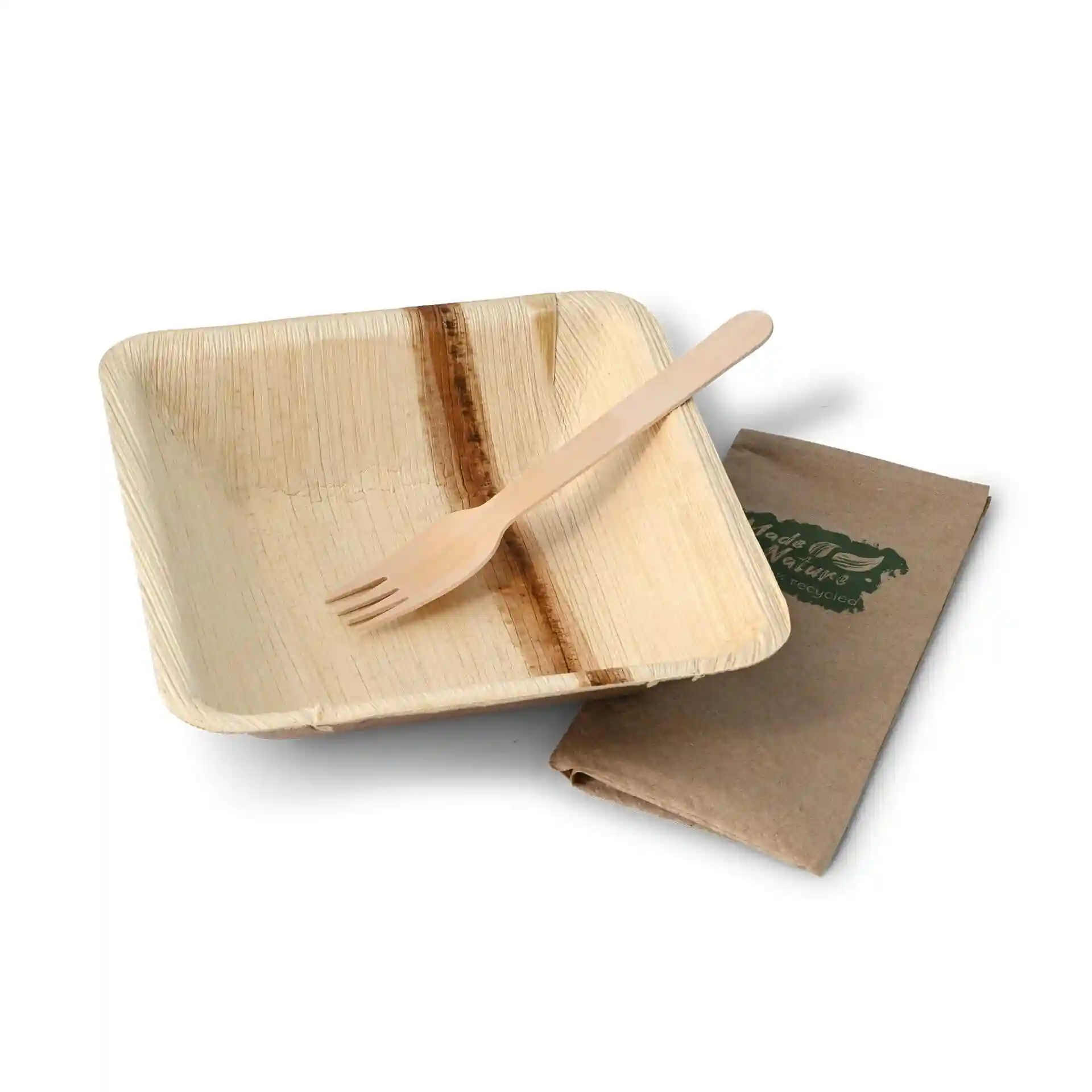 Square palm leaf bowl with a wooden fork and a folded brown napkin on a white background.