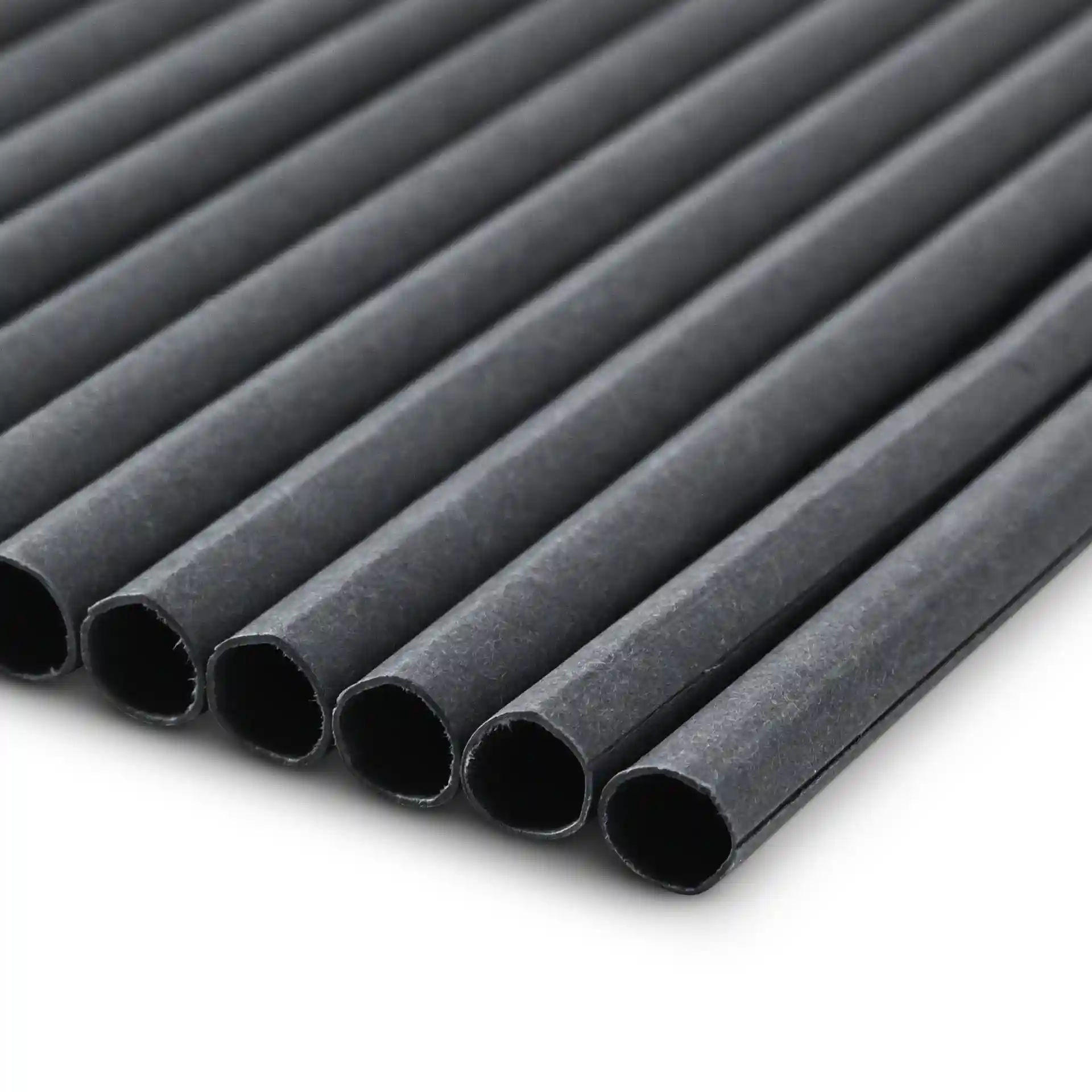 Black paper jumbo drinking straws, 23 cm long and 0.8 cm wide, arranged in a row on a plain background.