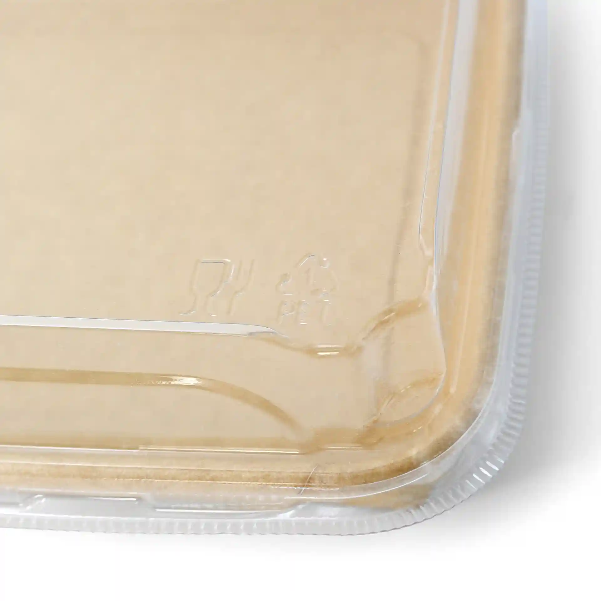 Transparent PET lid for sushi boxes, showing a corner with a slight curve and visible markings.