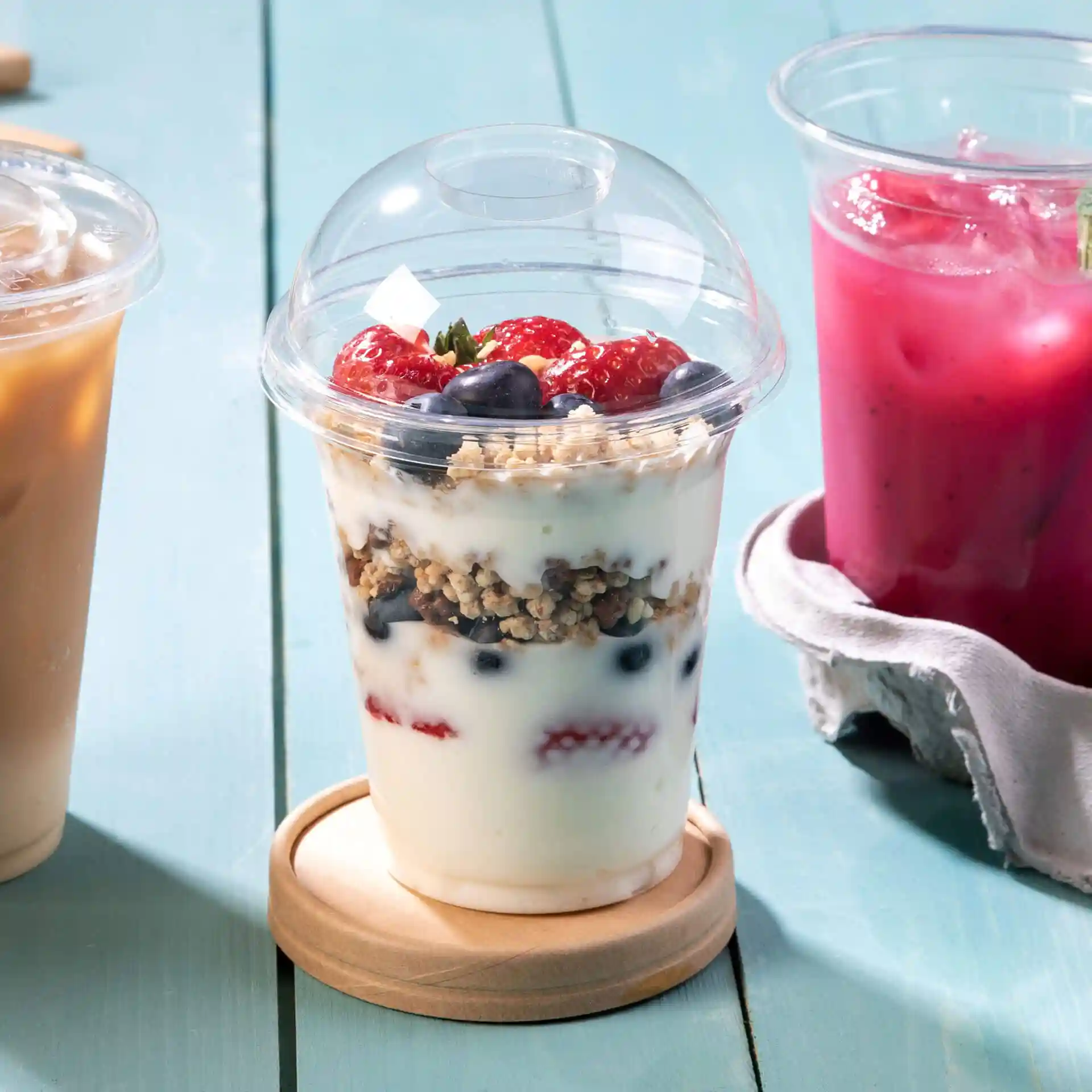 Transparent PLA dome lid with a diameter of 96mm, shown on a wooden coaster, with yogurt and fruit layers visible inside.