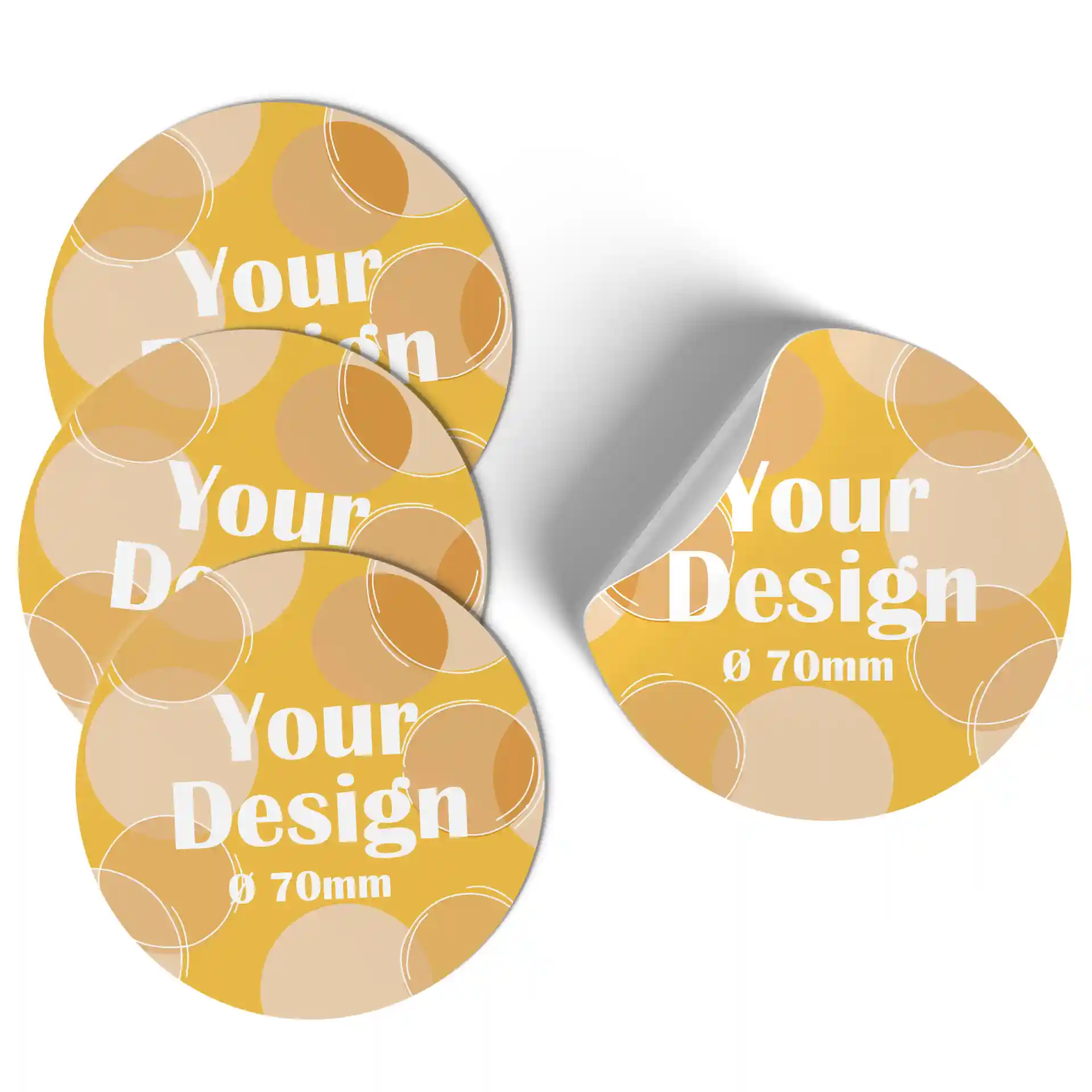 Round printed labels in yellow and beige patterns, 70 mm diameter, with a portion showing a curled edge.