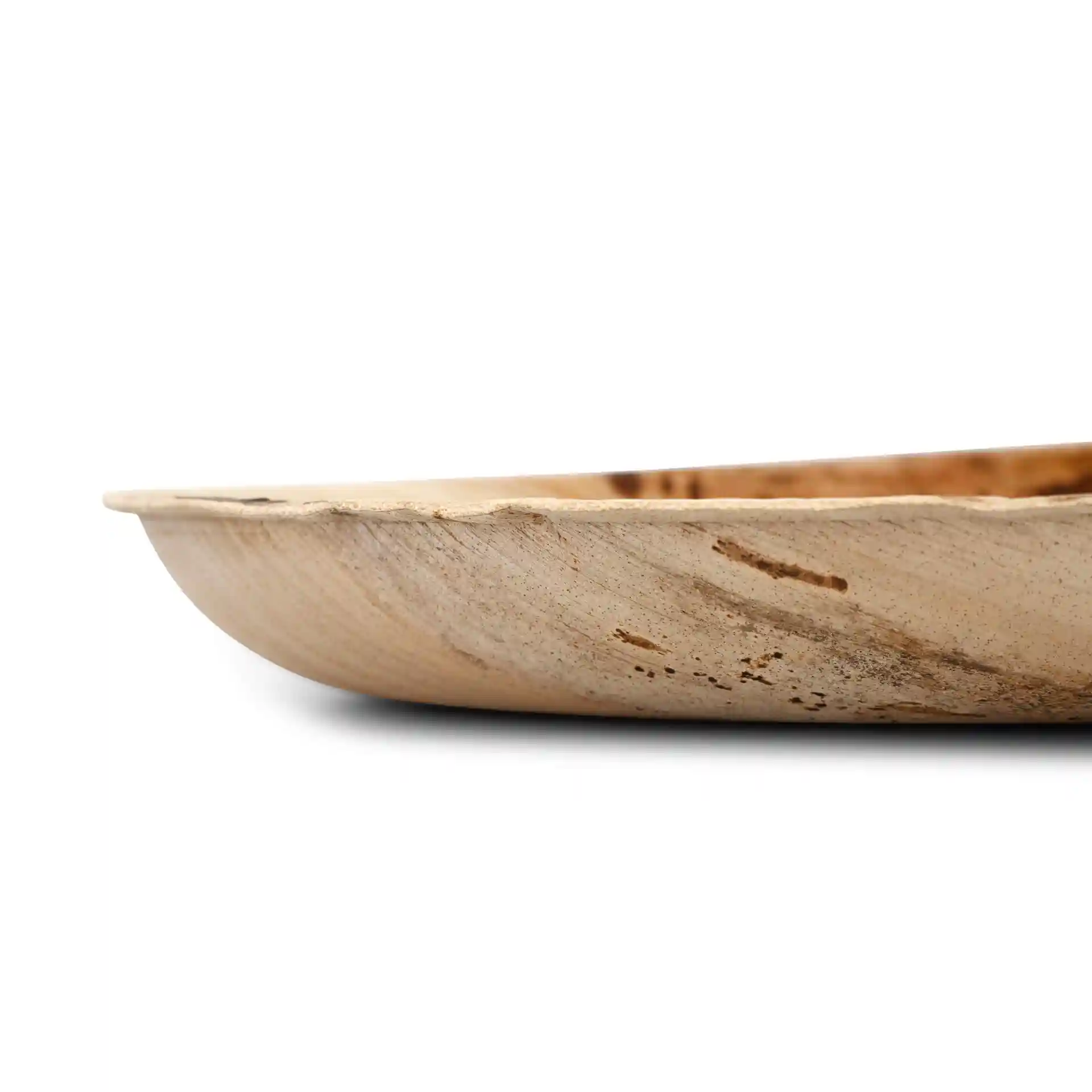 Shallow oval palm leaf plate with a natural grain finish, viewed from the side.