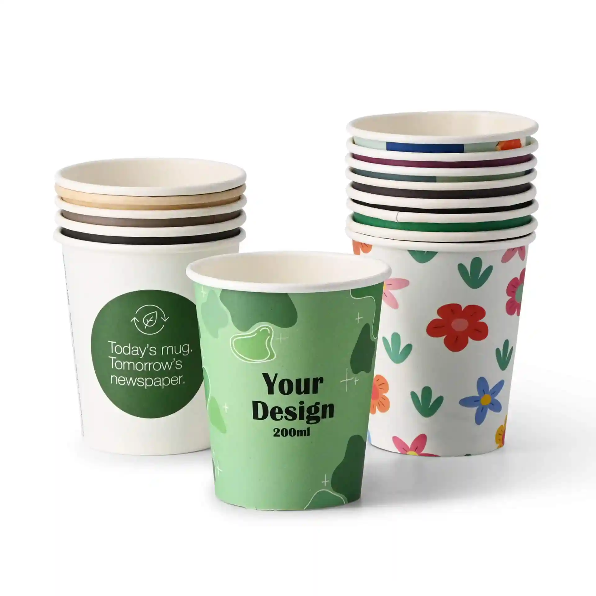 Stack of paper cups in various designs, including a green cup with "Your Design" and a floral pattern cup, on a white background.