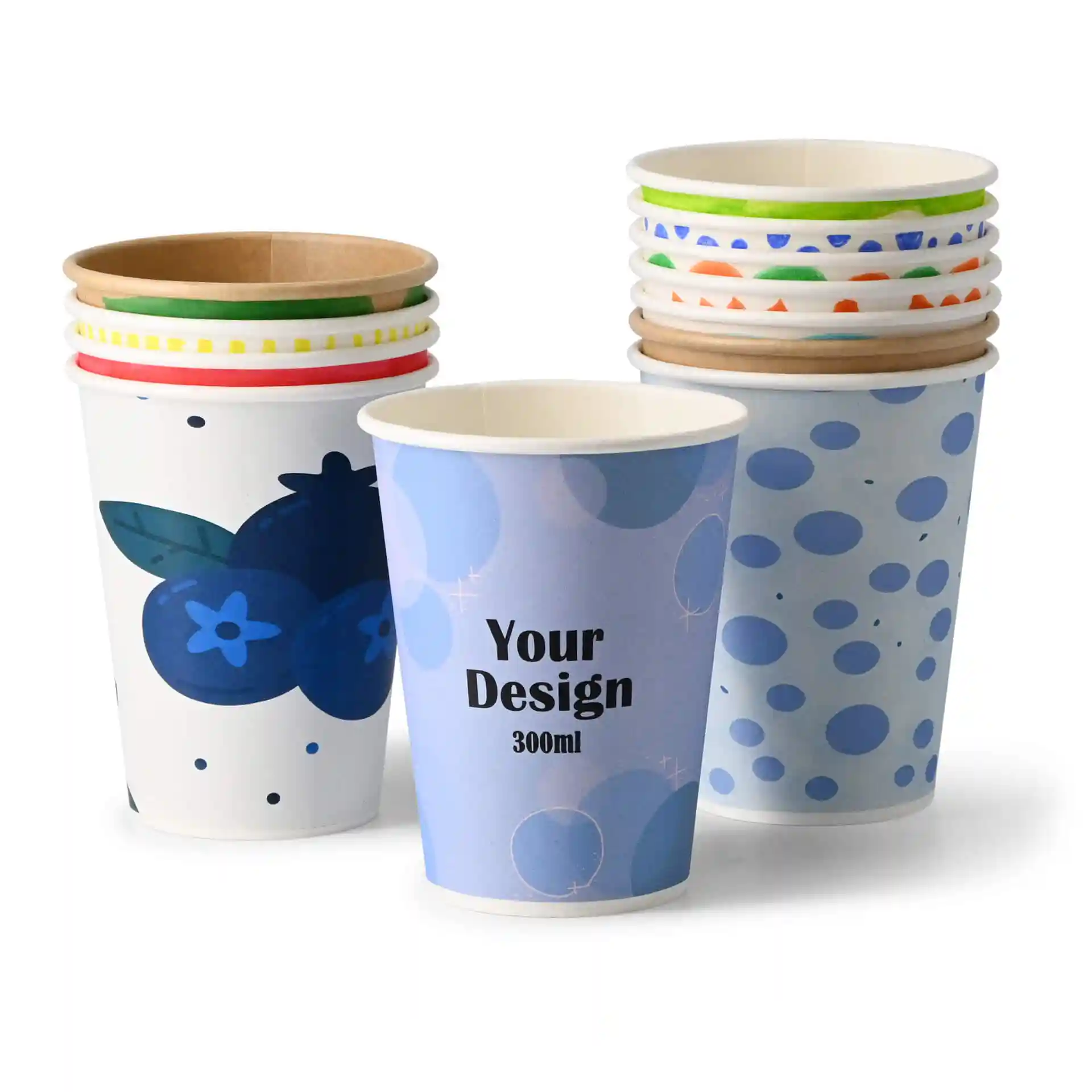 Paper cups with various designs, including a blueberry pattern and a blue polka dot pattern, stacked together.