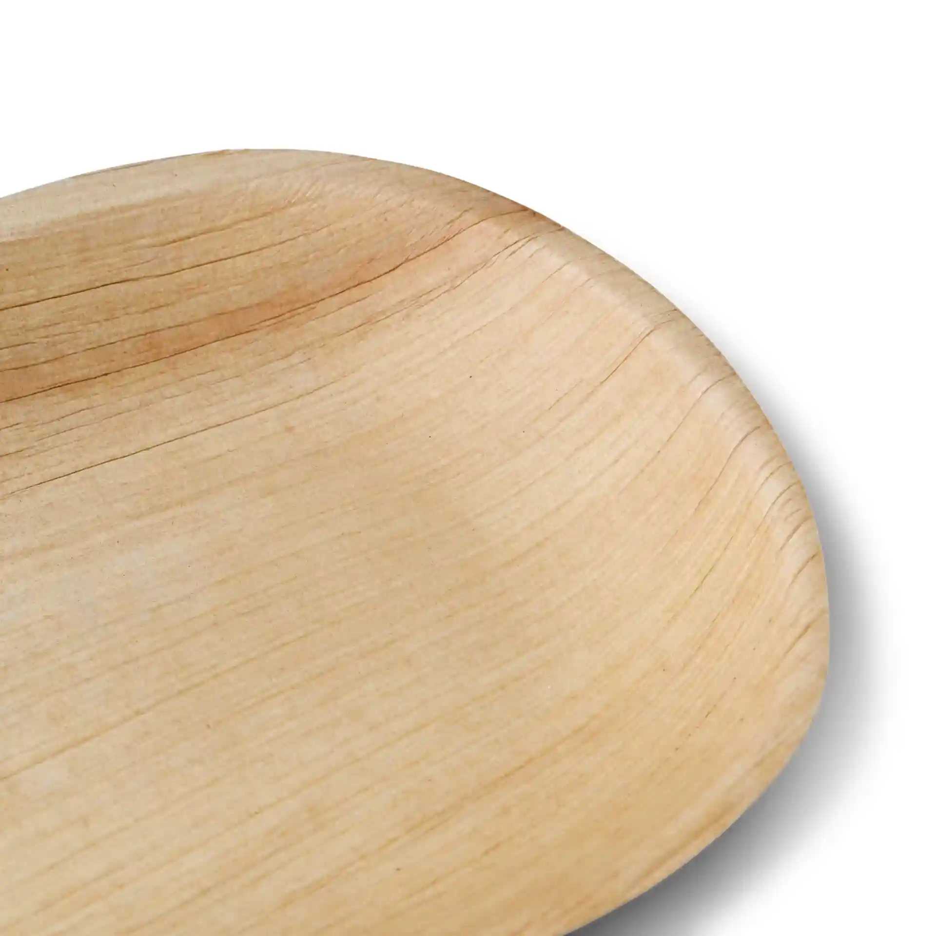 Close-up of an oval palm leaf plate with a natural grain finish and shallow depth.