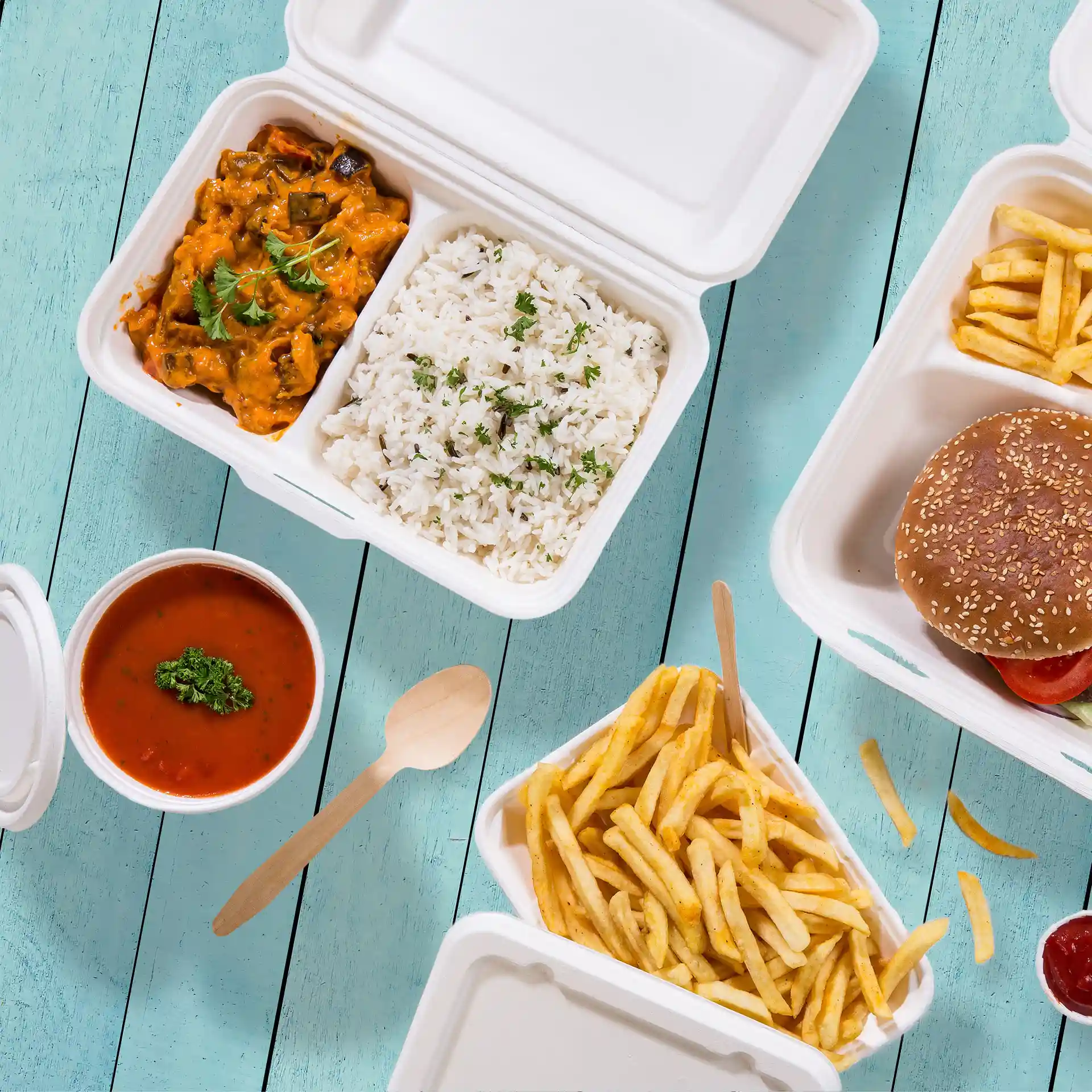 Image of a cream white sugarcane container with two compartments, containing rice, curry, fries, and a burger.