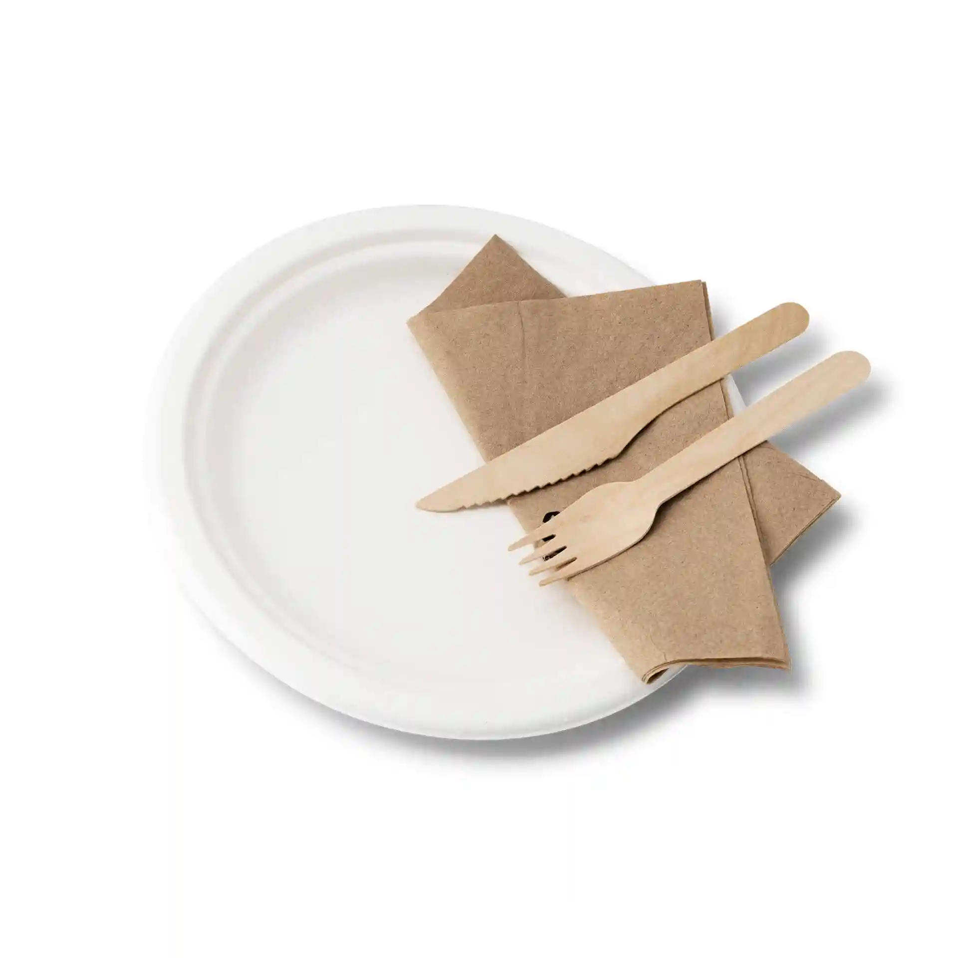 Round white sugarcane plate with a brown napkin and wooden knife and fork arranged on top.