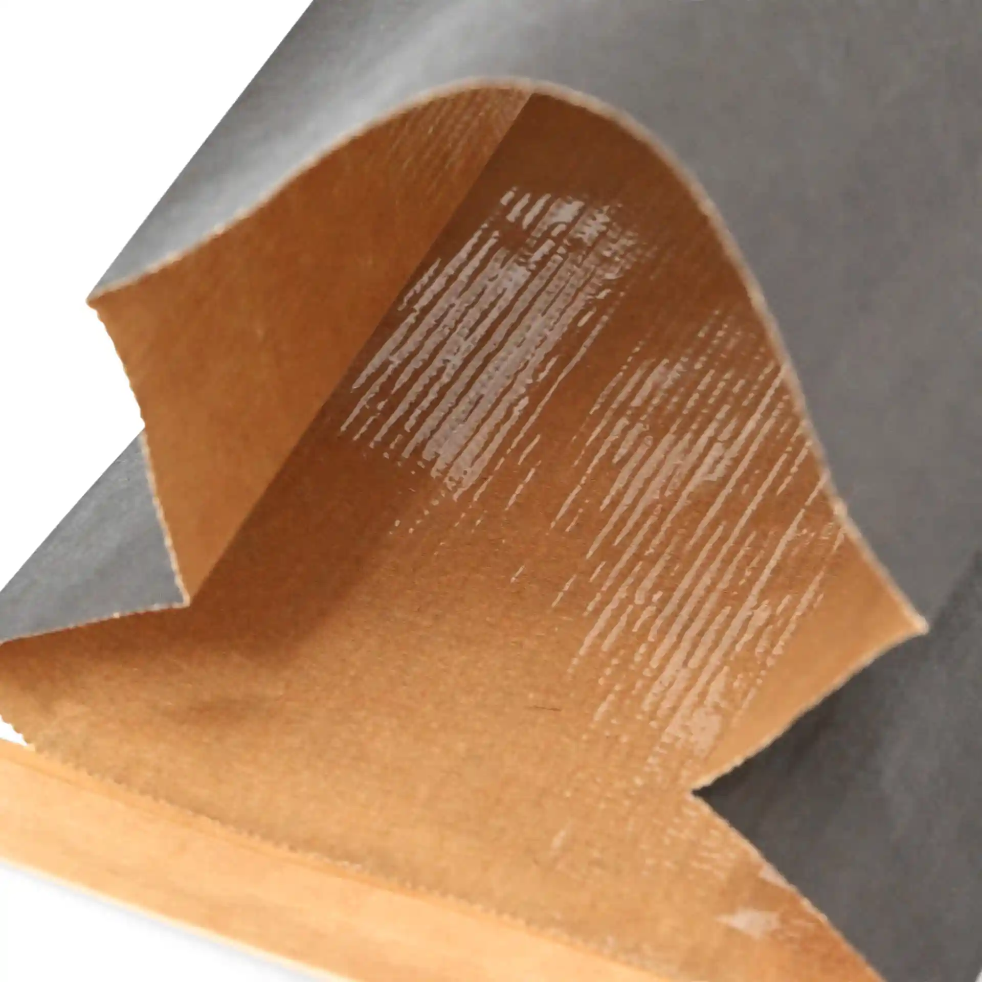 Close-up of a black block bottom bag made of kraft paper, showing the interior with a glossy coating and a tin tie.